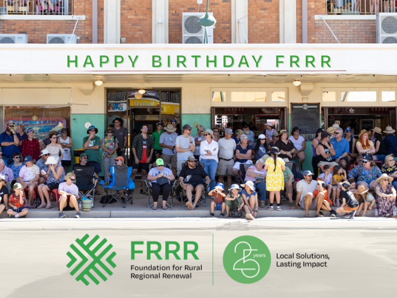 A group of people sitting on the side of street with overlay of Happy Birthday FRRR.