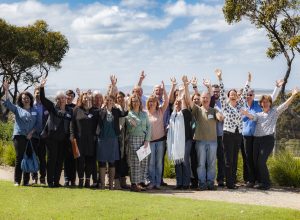 HEADING: FRRR welcomes extension of DGR1 to Rural Community Foundations IMAGE: Group shot of community group members with their hands in the air