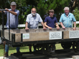HEADING: Forging friendships and recovery. IMAGE: Members of the Kingscote Men's Shed with the upgraded jetty trolly.