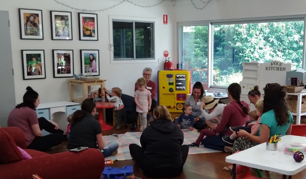HEADING: Flowerdale’s playgroup flourishes. IMAGE: Mothers and babies at playgroup.