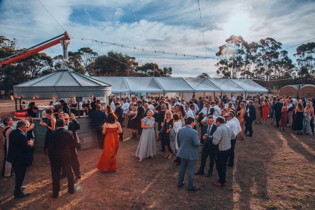 A crowd of people in evening wear in the outback