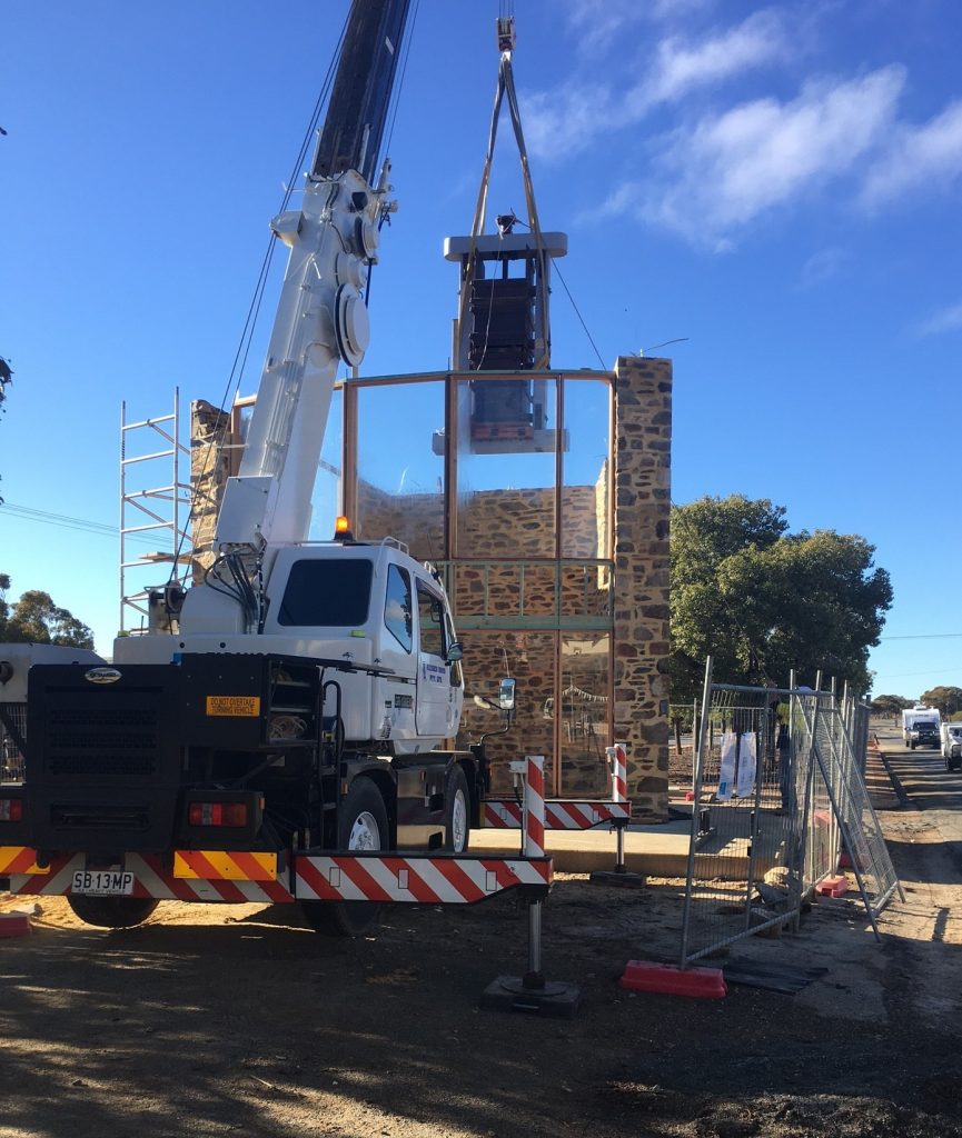 A truck mounted crane lifts materials in for the Orroroo rotunda rebuild