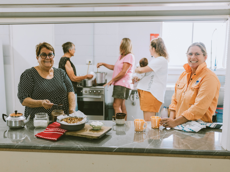 Women preparing food and tea in a kitchen